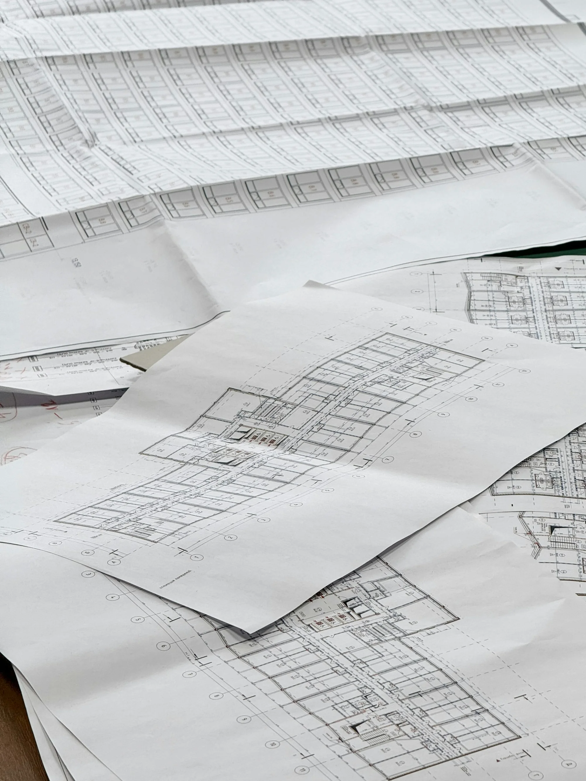 Architectural drawings spread across a work surface