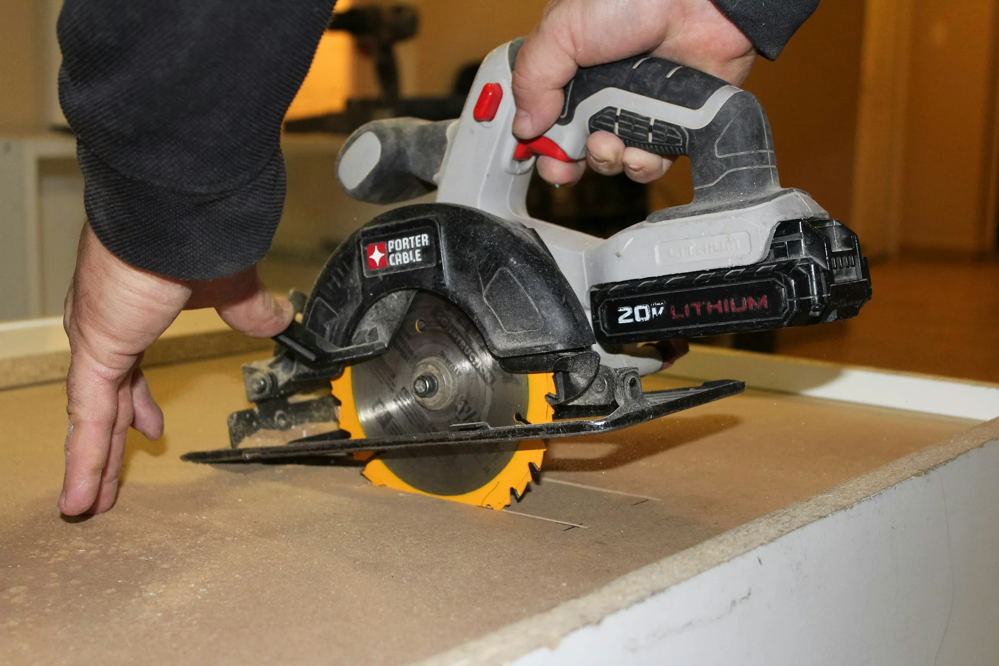 Carpenter carefully cutting a panel to size