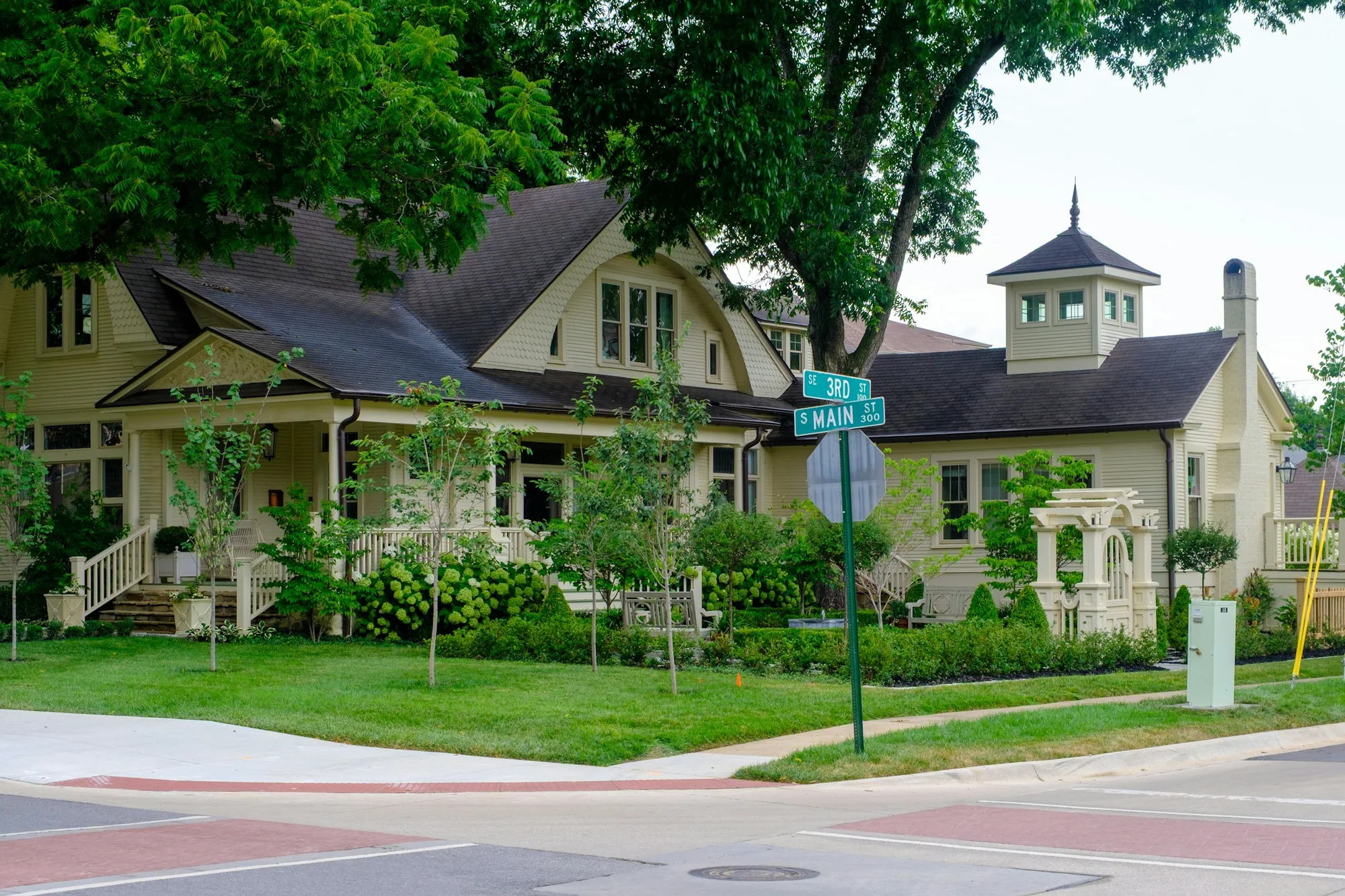 Established home with a front porch surrounded by trees